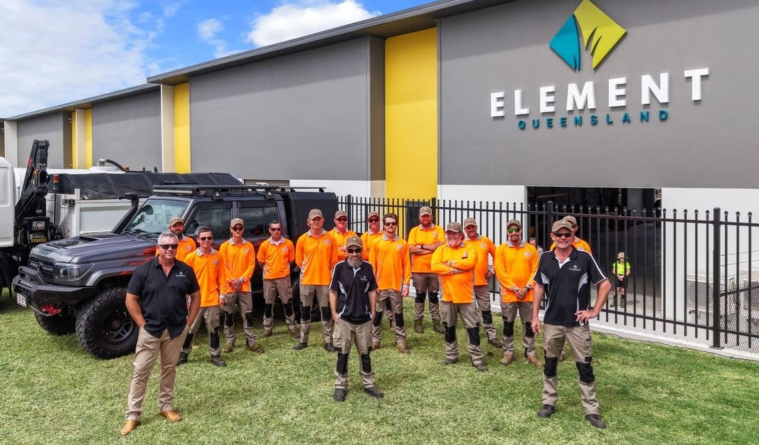 Element Queensland team gathered outdoors at sunset