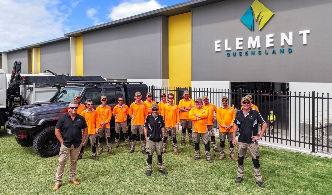 Element Queensland team gathered outdoors at sunset