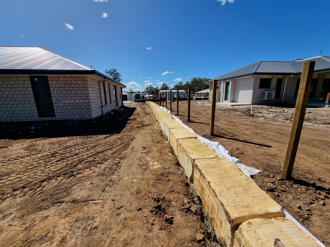Sandstone block retaining wall between residential lots