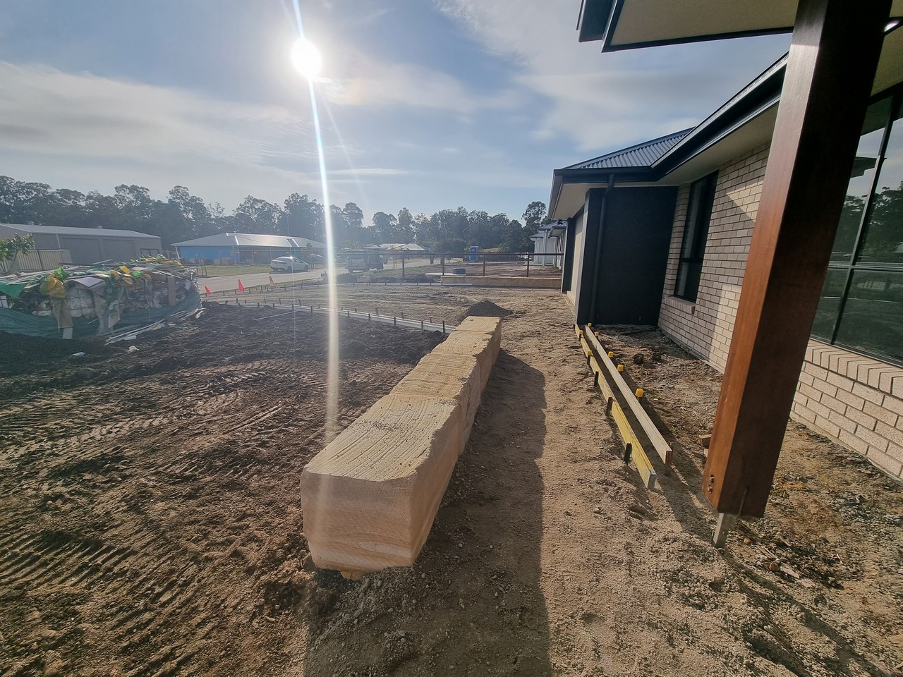 Sandstone retaining wall with timber formwork