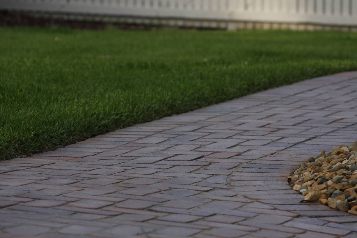 Detailed view of commercial paving and turf hardscape interface