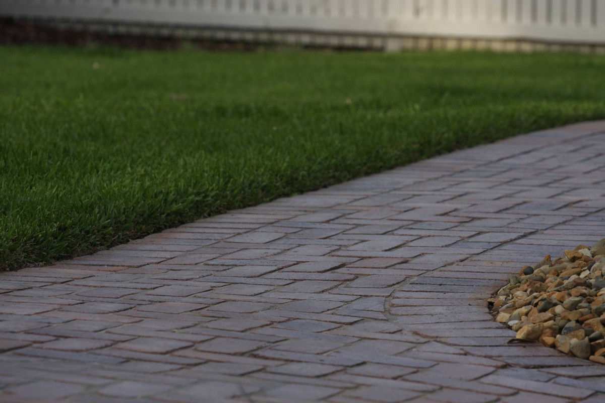 Detailed view of commercial paving and turf hardscape interface